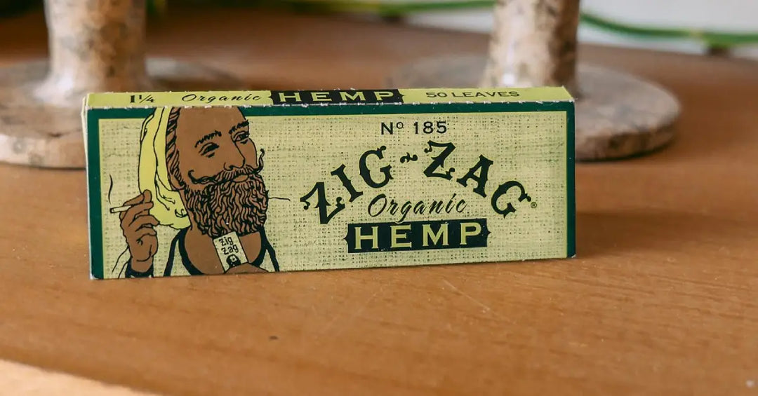 Organic hemp wraps in a classic Zig-Zag package, displayed on a rustic wooden surface.